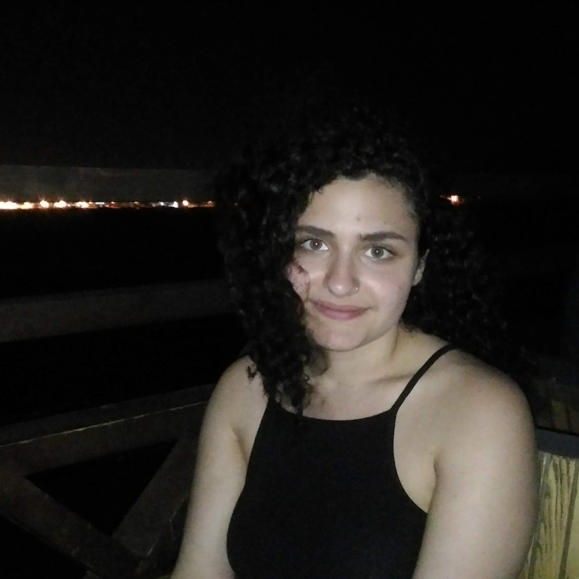 Sarah on a beach with a parrot
